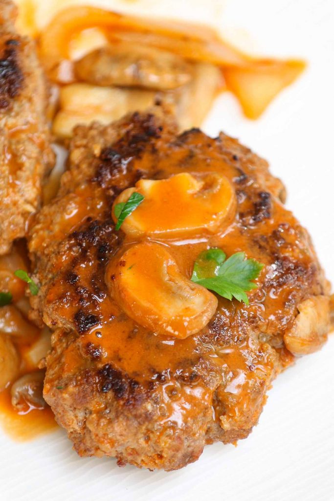 Bobby Flay Salisbury Steak is a comfort food that’s so easy to make. Juicy, well-seasoned beef patties are cooked to perfection in creamy, savory mushroom gravy. It couldn’t be easier to prepare a Salisbury steak recipe for a hearty weeknight dinner the whole family will enjoy.