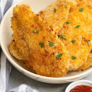 Crispy and crunchy Oven Baked Chicken Fillets are life-changing! Chicken breast fillets are soaked in lemon garlic flavors and then coated with a golden parmesan panko crumb. No mess, no flour needed, no deep-frying! This restaurant-quality recipe is so easy to make and popular with kids and adults!