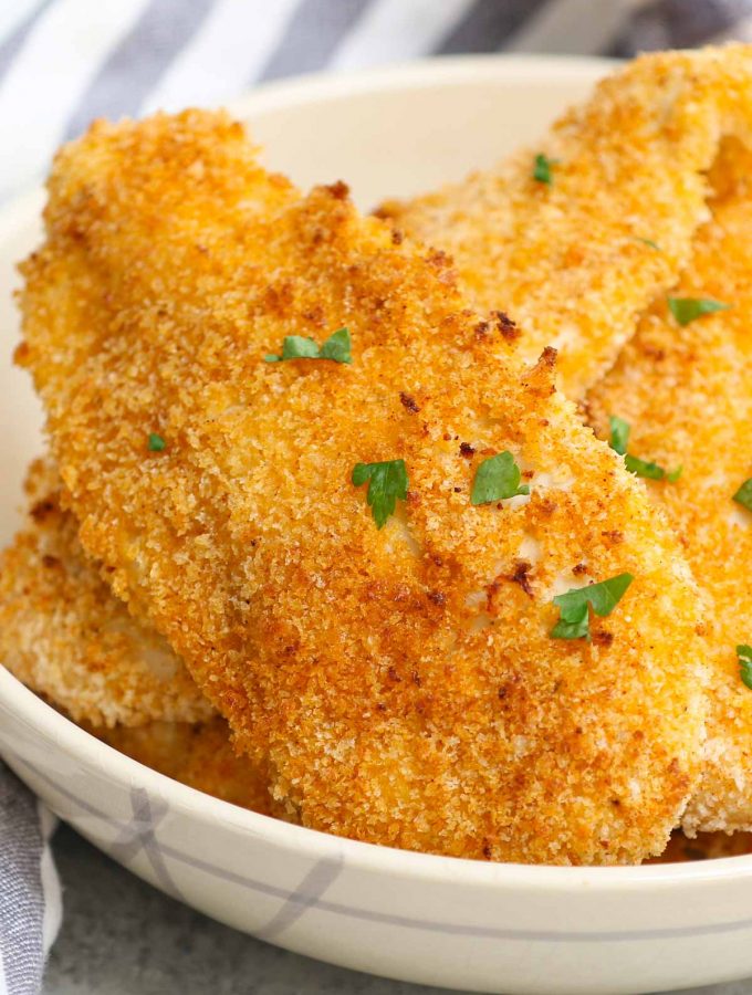 Crispy and crunchy Oven Baked Chicken Fillets are life-changing! Chicken breast fillets are soaked in lemon garlic flavors and then coated with a golden parmesan panko crumb. No mess, no flour needed, no deep-frying! This restaurant-quality recipe is so easy to make and popular with kids and adults!