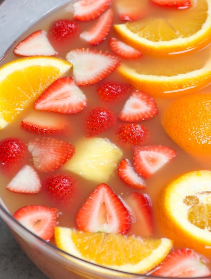 Jungle juice is the easiest, tastiest way to serve drinks at parties, holiday dinners, or for the Super Bowl! This affordable cocktail combines fruit juices and real fruit, with some rum and vodka to get the party started. This punch is sweet, tangy, and refreshing.