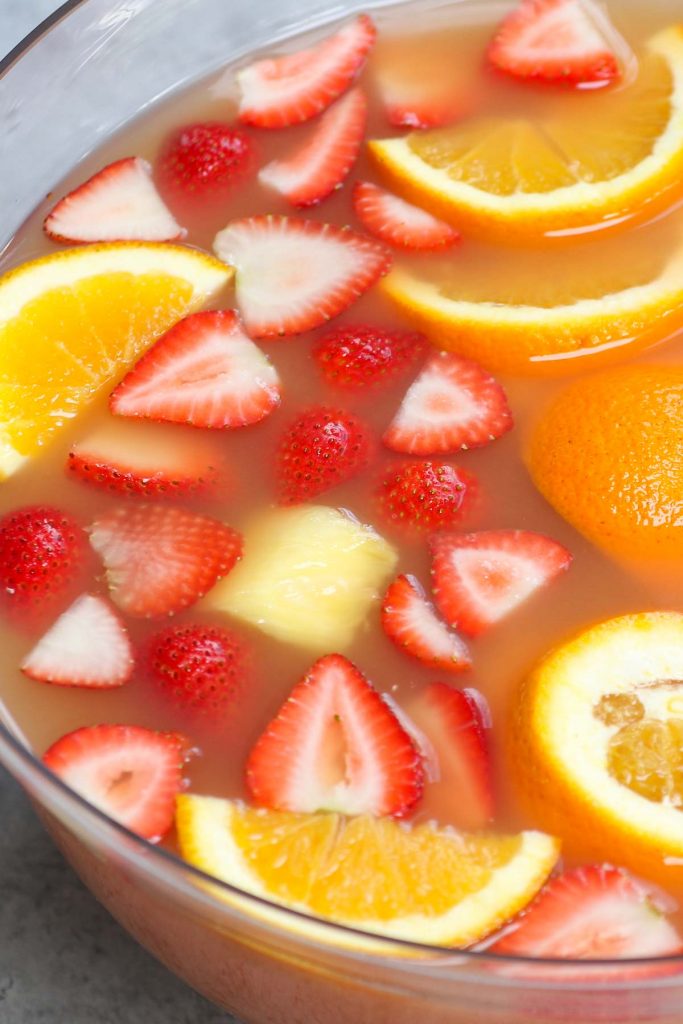 Jungle juice is the easiest, tastiest way to serve drinks at parties, holiday dinners, or for the Super Bowl! This affordable cocktail combines fruit juices and real fruit, with some rum and vodka to get the party started. This punch is sweet, tangy, and refreshing.