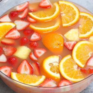 Jungle juice is the easiest, tastiest way to serve drinks at parties, holiday dinners, or for the Super Bowl! This affordable cocktail combines fruit juices and real fruit, with some rum and vodka to get the party started. This punch is sweet, tangy, and refreshing.
