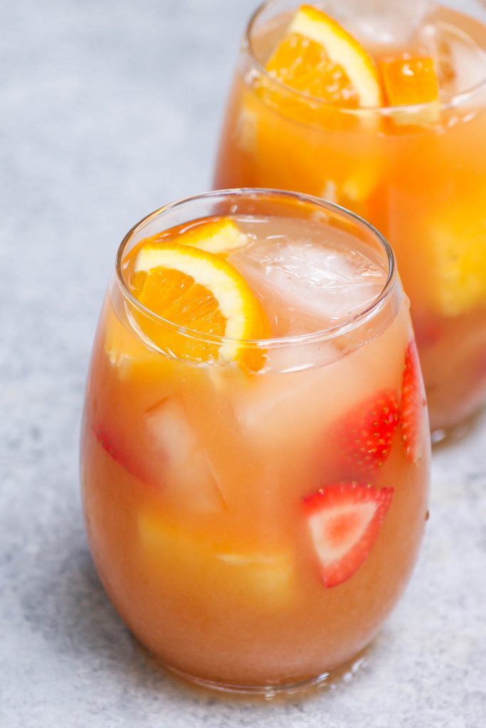 Jungle juice is the easiest, tastiest way to serve drinks at parties, holiday dinners, or for the Super Bowl! This affordable cocktail combines fruit juices and real fruit, with some rum and vodka to get the party started. This punch is sweet, tangy, and refreshing.