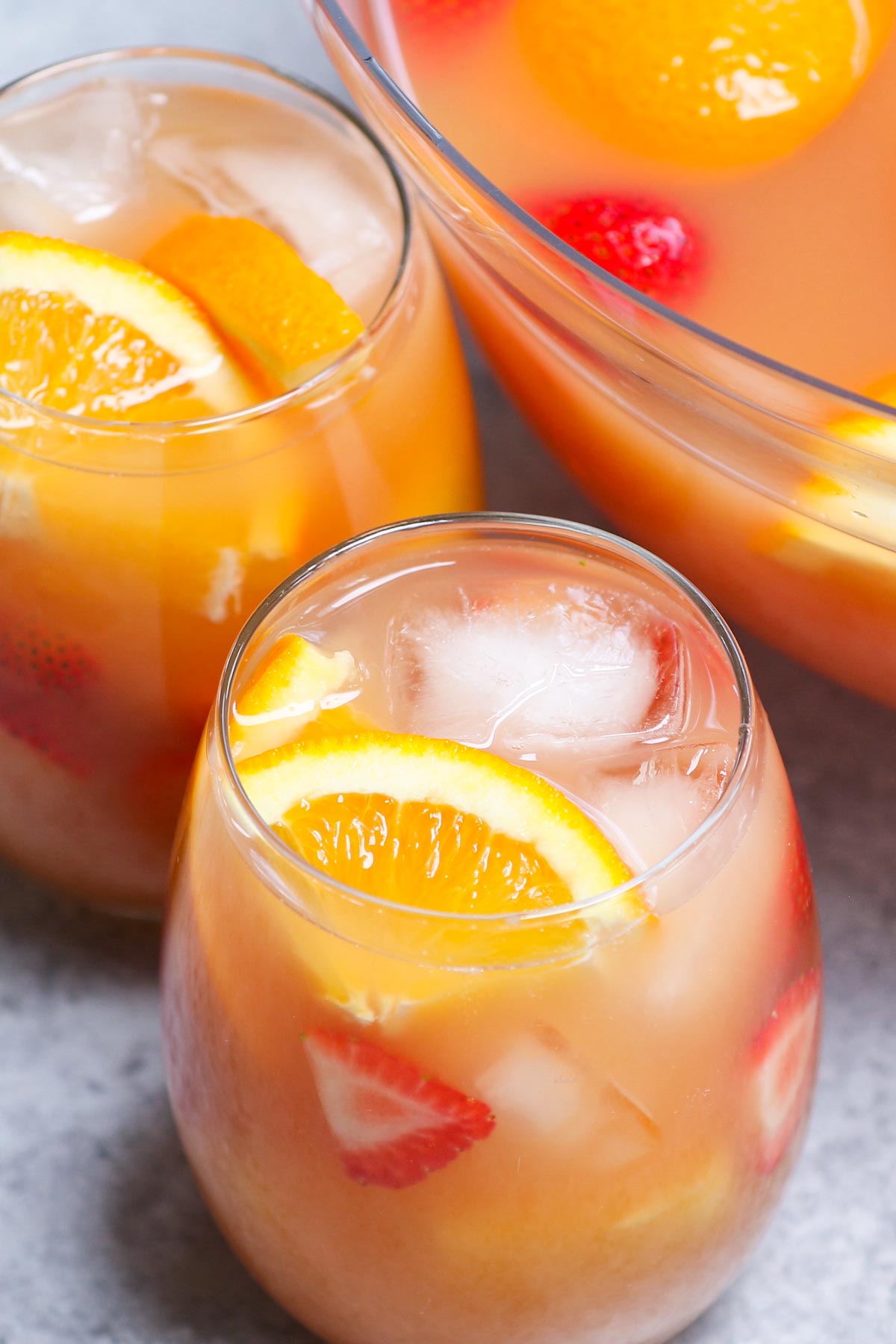 Jungle juice is the easiest, tastiest way to serve drinks at parties, holiday dinners, or for the Super Bowl! This affordable cocktail combines fruit juices and real fruit, with some rum and vodka to get the party started. This punch is sweet, tangy, and refreshing.