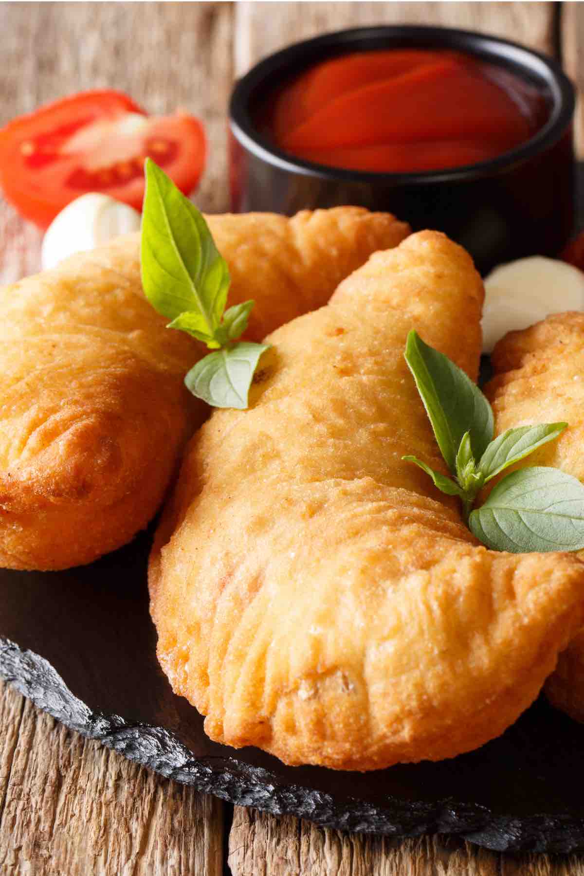 Easy Panzerotti (or Panzarotti) is an Italian savory turnover like a mini pizza pocket and it’s super easy to make at home! A pizza dough crust is filled with all the classic toppings – pepperoni, cheese, and your choice of sauce. These semi-circular pockets are then baked or deep-fried to golden perfection. If this sounds like something you might like (how can it not?), check out this authentic recipe.