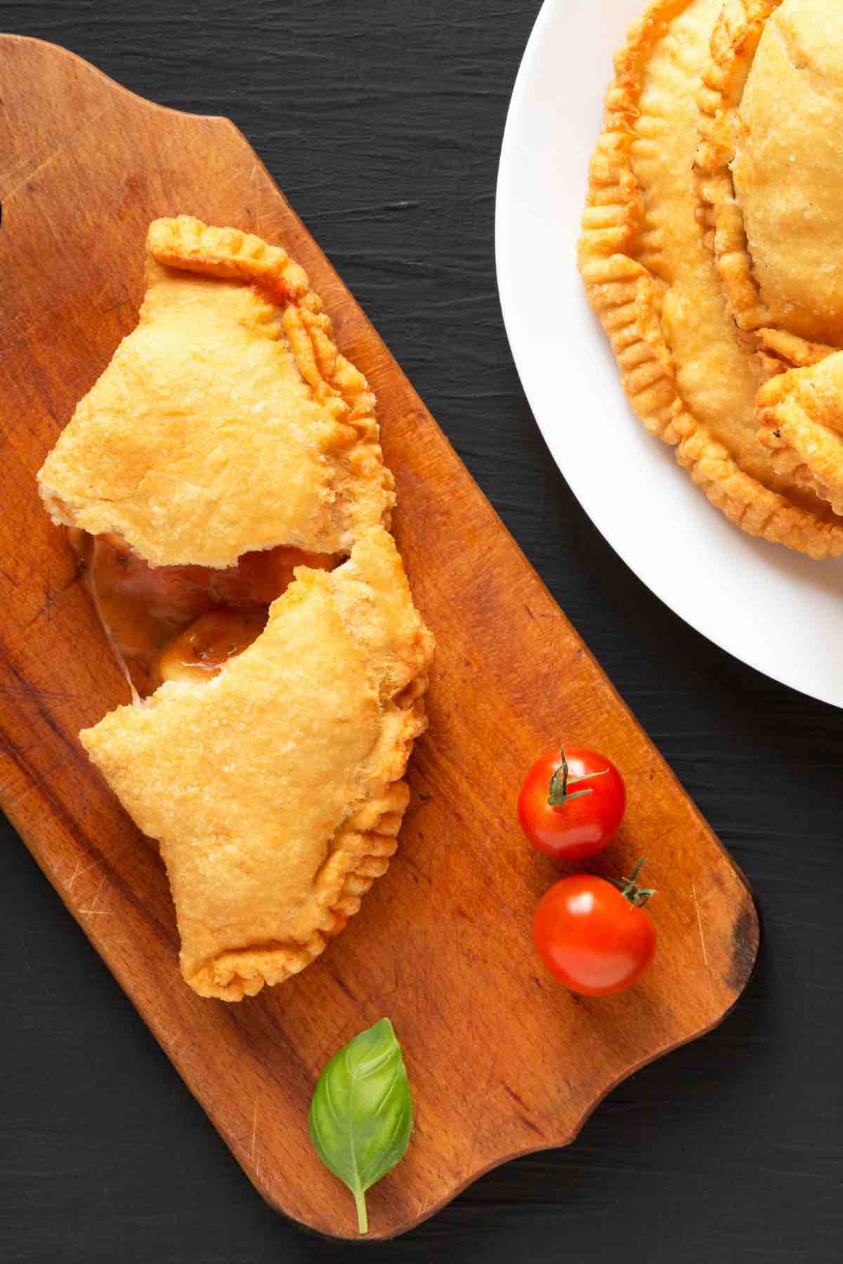 Easy Panzerotti (or Panzarotti) is an Italian savory turnover like a mini pizza pocket and it’s super easy to make at home! A pizza dough crust is filled with all the classic toppings – pepperoni, cheese, and your choice of sauce. These semi-circular pockets are then baked or deep-fried to golden perfection. If this sounds like something you might like (how can it not?), check out this authentic recipe.