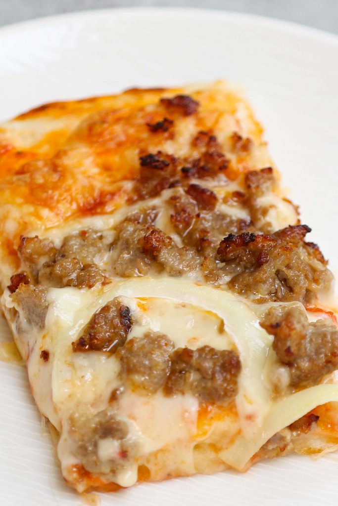 If you’re searching for a nostalgic meal, it doesn’t get any better than Old School Cafeteria Pizza. Remember when Friday was Pizza Day and the cafeteria ladies would serve up rectangular slices of cheesy, doughy pizza? Now, you can recreate this classic School Pizza at home, or customize it with your favorite add-ins and make it into school breakfast pizza or school lunch pizza.