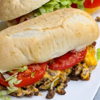 New York City’s Chopped Cheese Sandwich with chopped beef burgers, melted gooey cheese, caramelized onions, topped with tomatoes and shredded lettuces, and hugged by a toasted hero roll. This is the classic way to make the iconic NYC chopped cheese. It reminds me of Philly cheesesteak, but even better!
