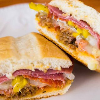 Cuban Sandwiches are loaded with roast pork, salami, ham, melting Swiss Cheese, pickles and yellow mustard. It’s one of the most popular Cuban recipes.