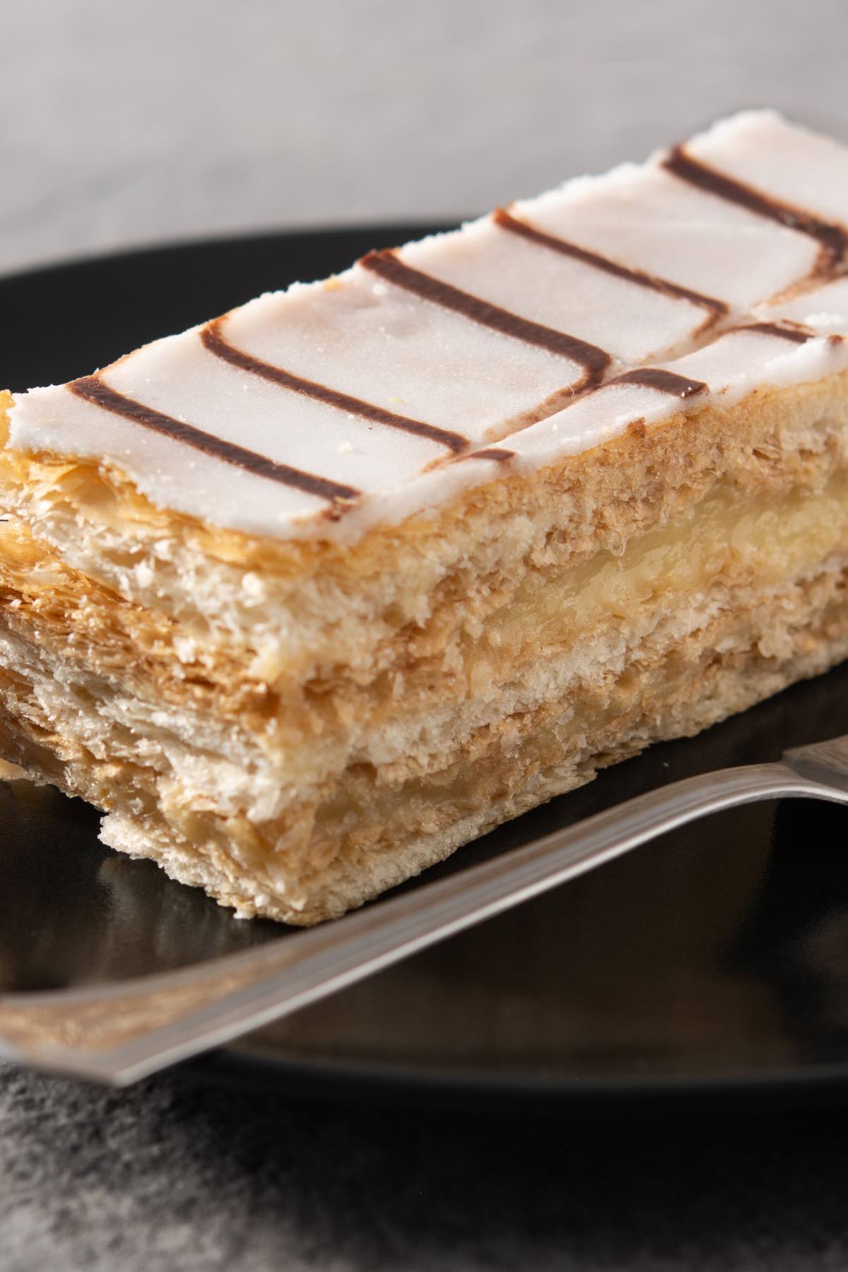 Napoleon Dessert is a classic blend of flaky pastry and creamy filling with a rich yet light taste and texture. Similar to Mile Feuille, it can be paired with tea or coffee for a great afternoon treat or an after-dinner dessert.