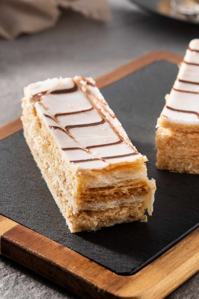 Napoleon Dessert is a classic blend of flaky pastry and creamy filling with a rich yet light taste and texture. Similar to Mile Feuille, it can be paired with tea or coffee for a great afternoon treat or an after-dinner dessert.