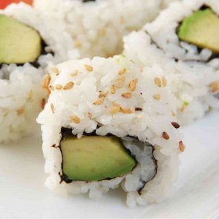 Avocado Sushi Rolls are a vegan variation of the popular California Roll. There’s something so satisfying about making your own sushi at home. Not only is it much cheaper than going to a restaurant, it’s also a super fun skill to learn! This creamy and delicious avocado roll recipe calls for a few simple ingredients and is easy to make at home.
