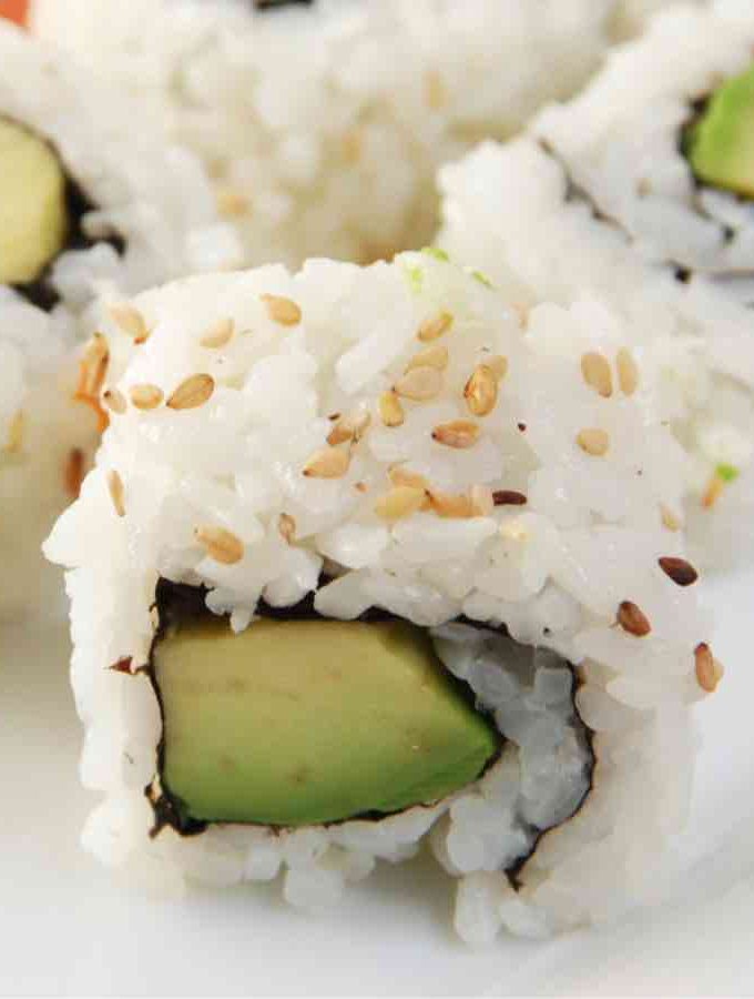Avocado Sushi Rolls are a vegan variation of the popular California Roll. There’s something so satisfying about making your own sushi at home. Not only is it much cheaper than going to a restaurant, it’s also a super fun skill to learn! This creamy and delicious avocado roll recipe calls for a few simple ingredients and is easy to make at home.