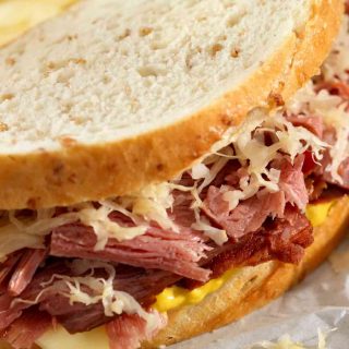 The ultimate Pastrami Sandwich piled high with thinly sliced pastrami, Swiss cheese, and coleslaw. These Artisan sandwiches are perfect for a hearty meal. Serve hot or cold with your favorite fries and veggies!