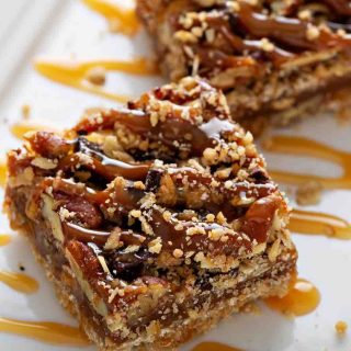 These pecan pie bars have a buttery crust with a sweet and crunchy pecan pie topping. It’s one of my favorite pecan recipes.
