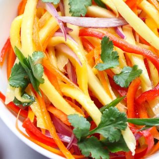 Mango Salad is loaded with raw fresh mango, carrots, bell pepper, onions, and crunchy peanuts – one of our favorite raw vegan recipes. Toss it with a delicious peanut dressing for the most refreshing salad!