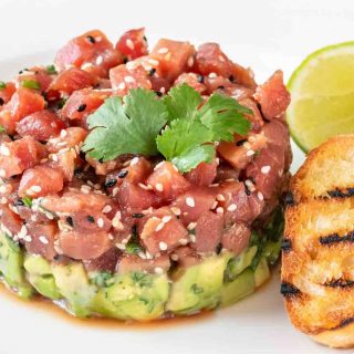 Tuna tartare is a delectable, yet simple dish, consisting of cubes of raw, sashimi-grade tuna that has been lightly seasoned. The tuna is placed atop creamy avocado for a flavor combo that’s out of this world.