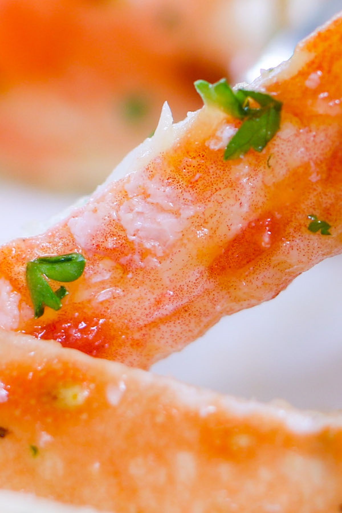 Close-up of crab leg meat with parsley and butter