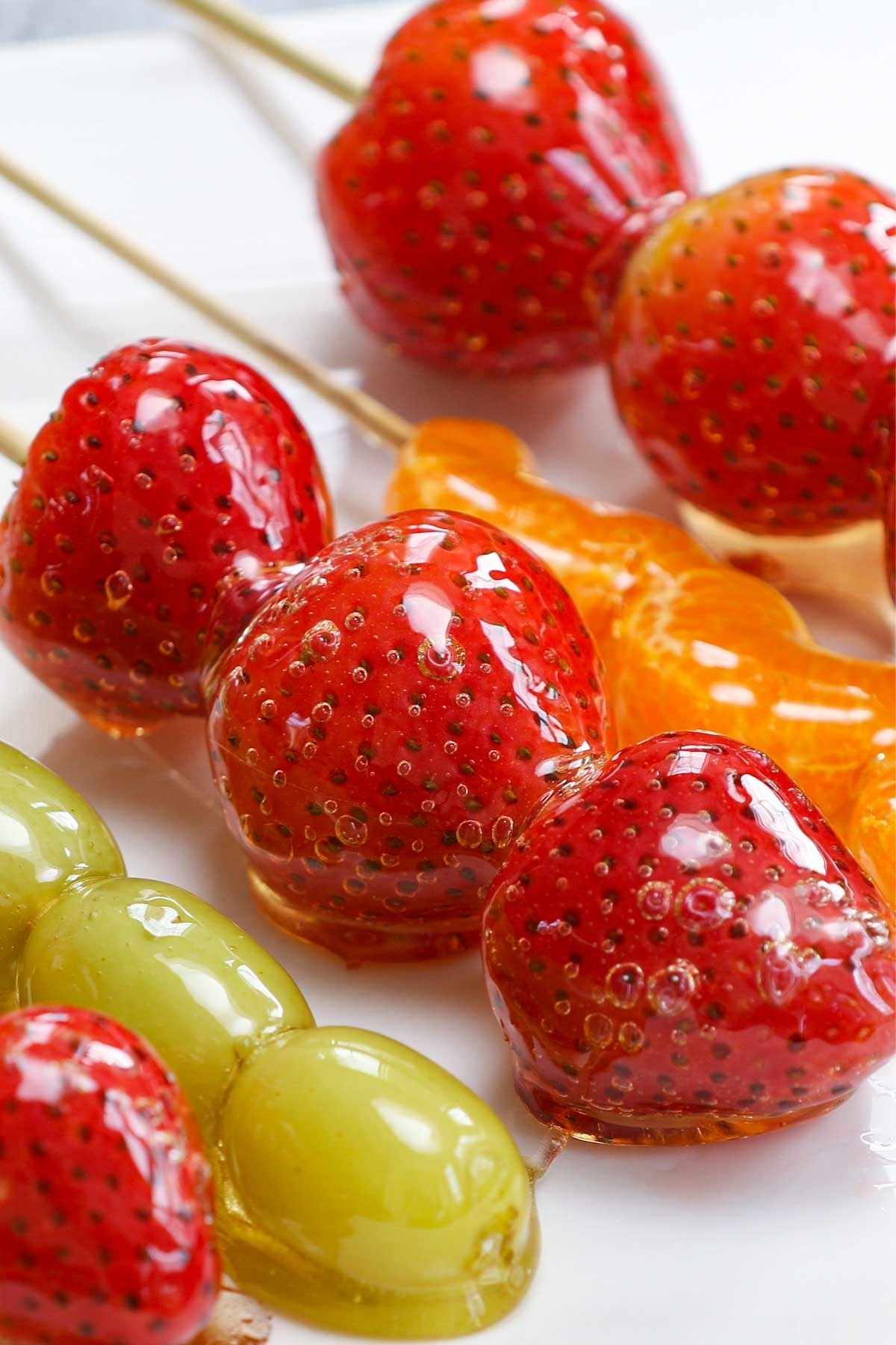 Also called Tanghulu, these Candied Fruits are as pretty as they are delicious. Juicy strawberries, grapes or tangerine wedges are coated in a hardened sugar syrup that forms a sweet crunchy shell around the fruit.
