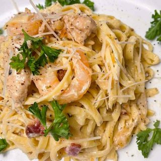 Tired of boring mid-week lunches? Kick it up a notch with this tasty Chicken and Shrimp Carbonara, just like they do at Olive Garden! Made with fresh, flavorful ingredients and seasoned with herbs, this is a meal the whole family will enjoy.