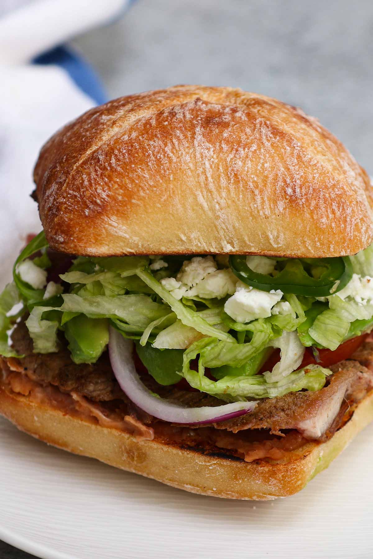 If you’re looking to enjoy iconic sandwiches from all over the world, the Mexican Torta has to be on your list! This Torta Mexicana recipe combines a juicy, well-seasoned sirloin steak with your favorite Mexican ingredients like refried beans and cojita cheese. Make it spicy with sriracha and jalapeños! 