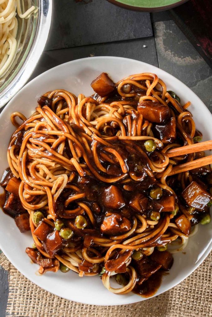 Korean Instant Jajangmyeon Black Bean Noodles are one of the most popular dishes in Korea. They’re rich, full of flavor, and make for quick meals. These noodles are coated and tossed in a smooth, savory, umami-flavored black bean sauce along with diced pork, zucchini, and onion.