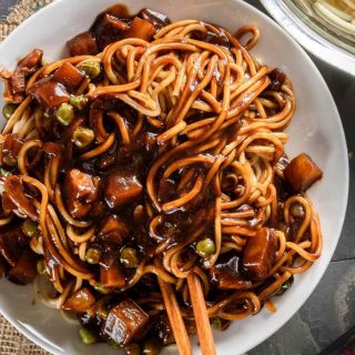 Korean Instant Jajangmyeon Black Bean Noodles are one of the most popular dishes in Korea. They’re rich, full of flavor, and make for quick meals. These noodles are coated and tossed in a smooth, savory, umami-flavored black bean sauce along with diced pork, zucchini, and onion.