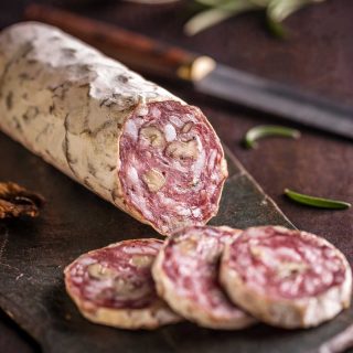 Enjoyed in sandwiches, on pizzas, and on charcuterie boards, salami is one of the most popular dried and cured sausages. Apart from being made with pork, what else gives salami its delicious flavor?