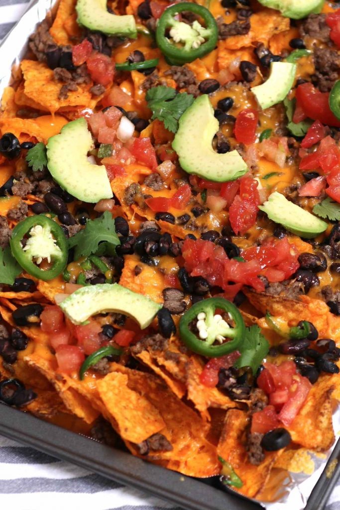 Want to know a neat trick for making the best nachos at home? Use Doritos! Instead of plain tortilla chips, these Dorito Nachos are made with flavorful Doritos chips. Add all your favorite toppings and pop it in the oven for the ultimate snack!