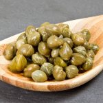 Capers add a flavor to dishes that’s salty, briney with a touch of lemon. They have a distinctive taste that packs a lot of punch.