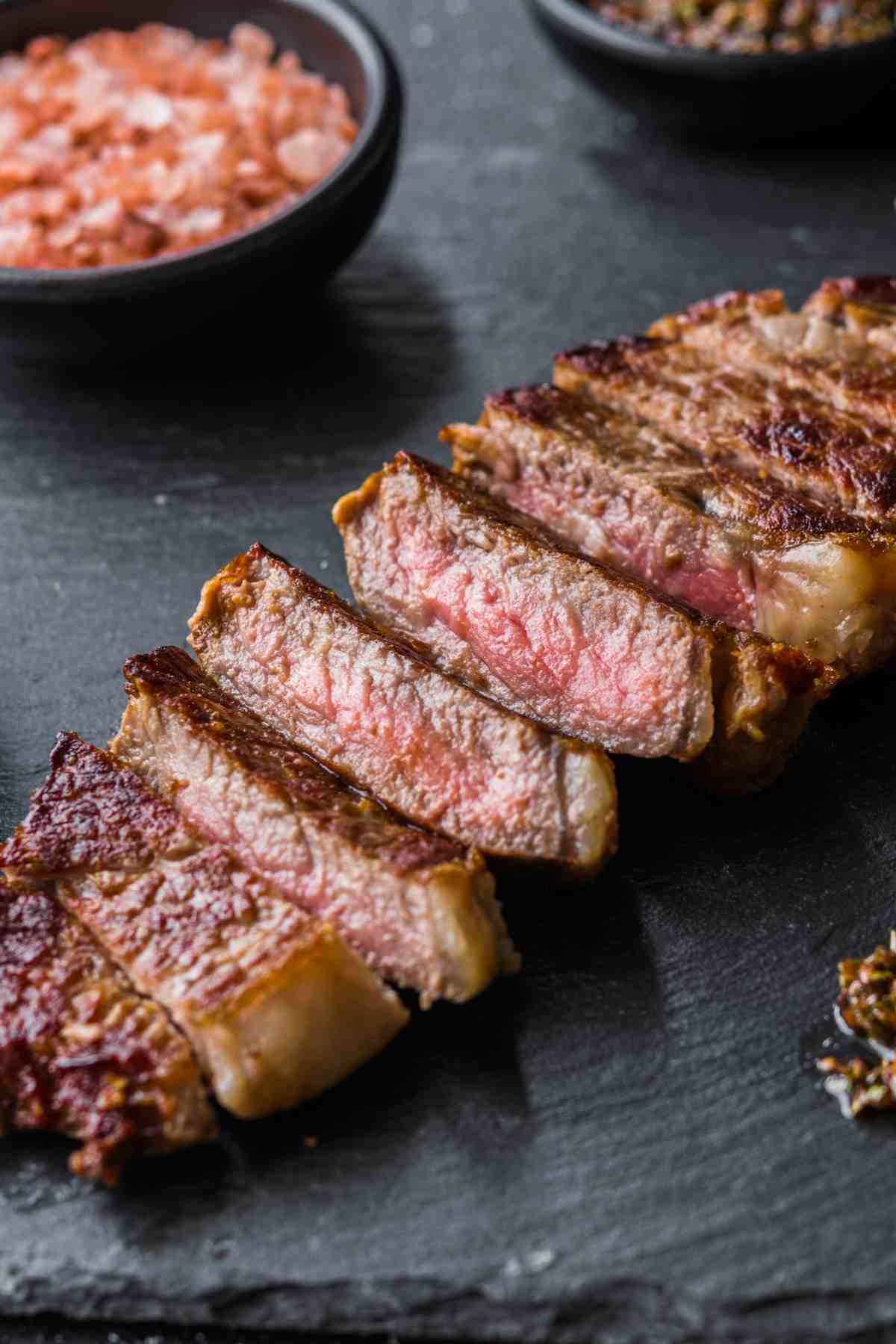 Sear these NY strip steaks in a cast iron skillet for a crust that’s perfectly caramelized. They take about 15 minutes to cook and the recipe includes guidelines on how to cook them to your liking.