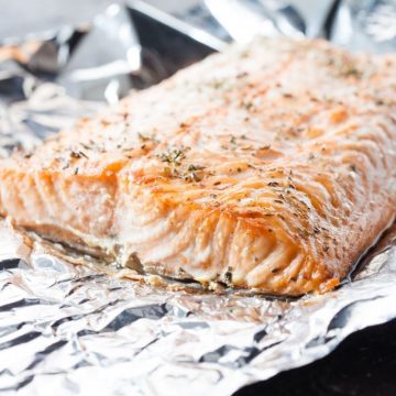 This Baked Salmon In Foil is moist and perfectly tender. It’s seasoned with garlic, fresh rosemary, lemons, salt, and pepper – ingredients that perfectly complement the buttery flavor of the salmon!