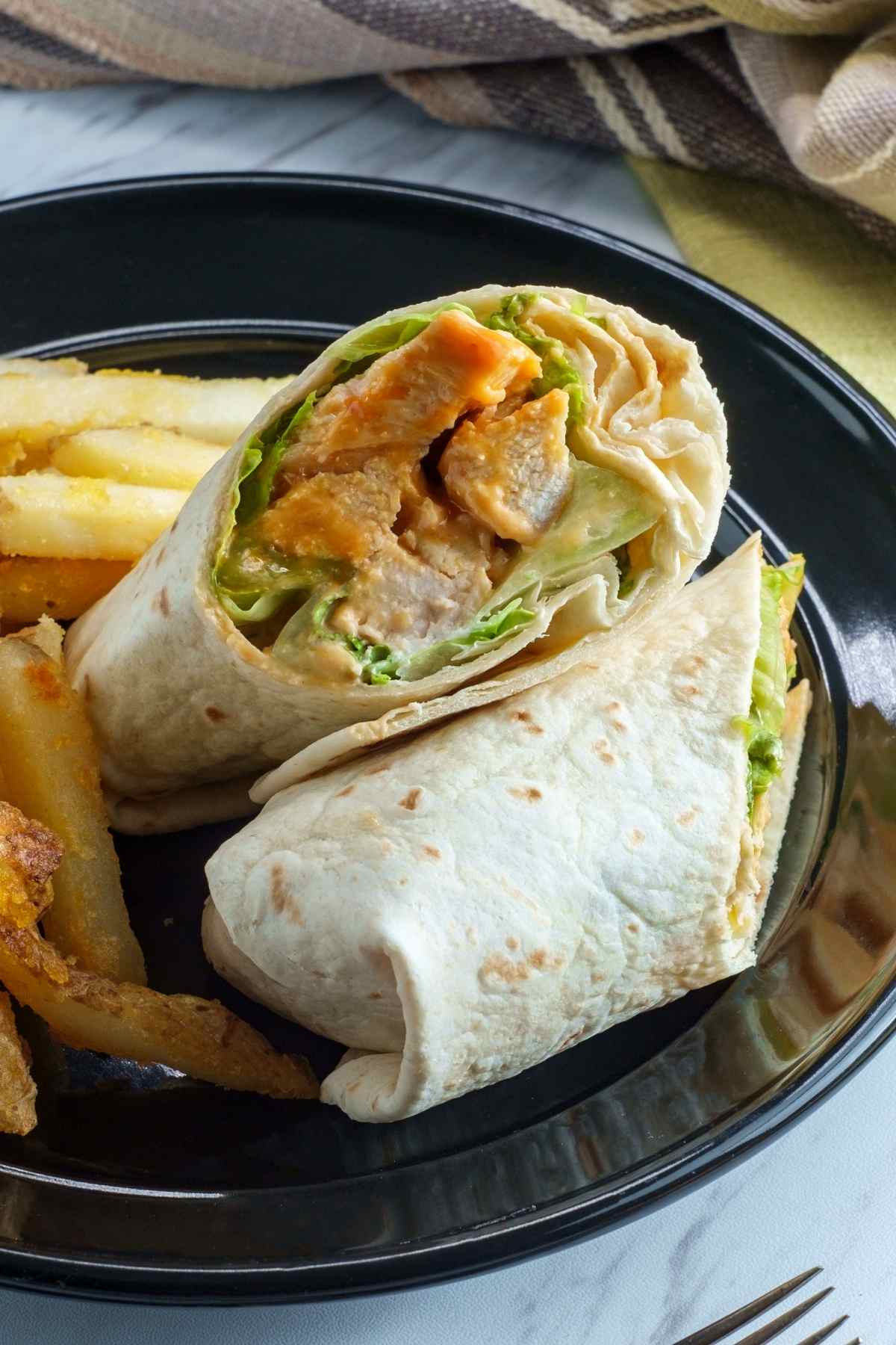 This copycat of McDonald’s grilled chicken snack wrap is perfect for a satisfying lunch. The chicken is seasoned with paprika, garlic powder, oregano, and cumin, and the wrap is drizzled with store-bought ranch dressing to save time.