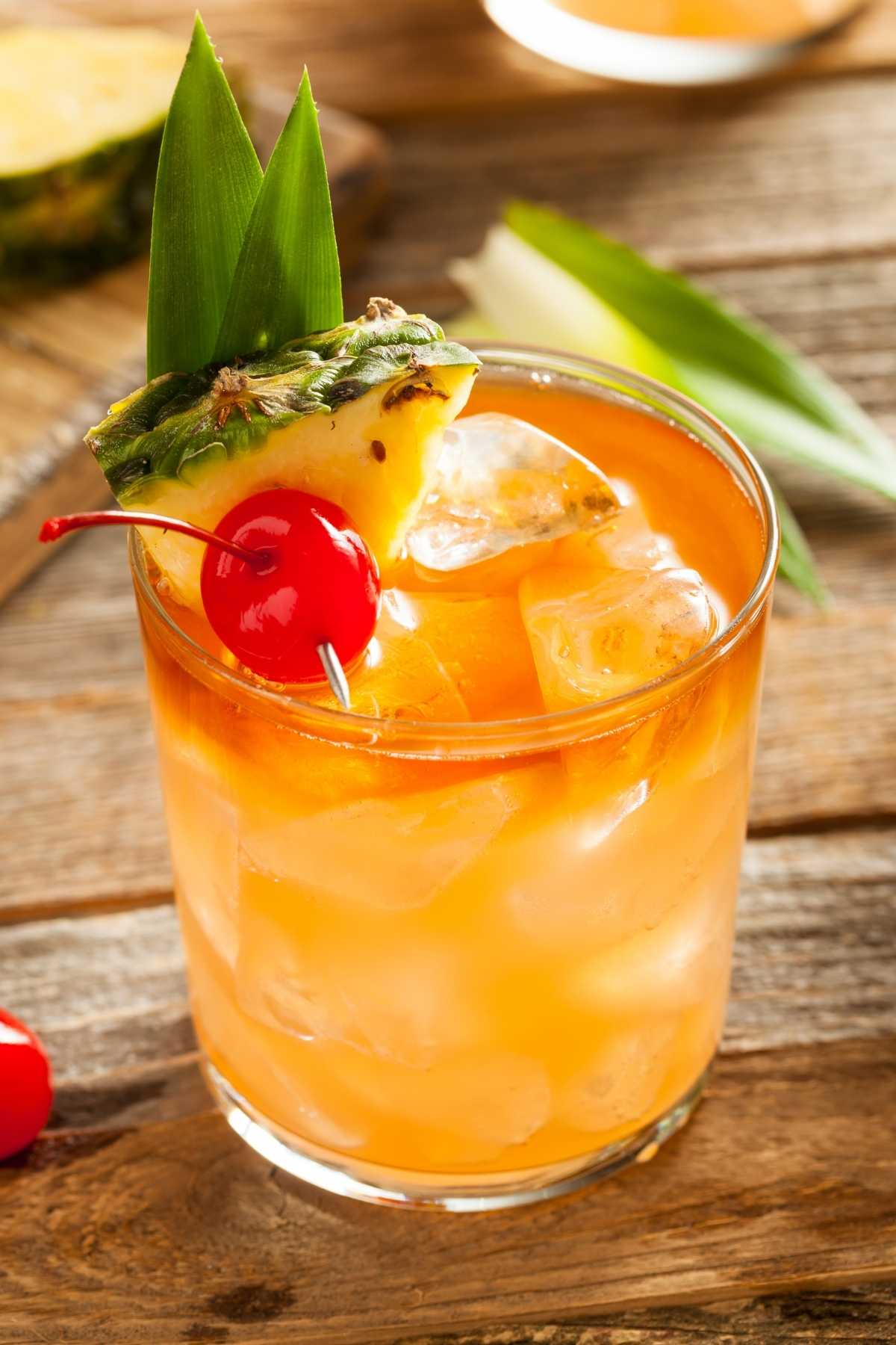 This classic Mai Tai cocktail is boozy, colorful, and delicious! It features two kinds of rum, orange curaçao, lime juice, and orgeat syrup.