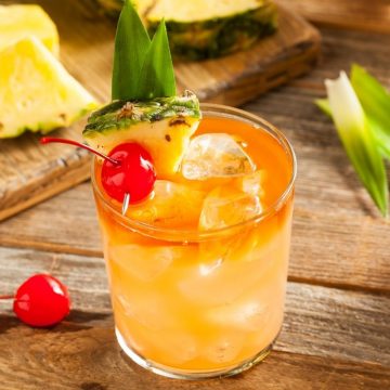 This classic Mai Tai cocktail is boozy, colorful, and delicious! It features two kinds of rum, orange curaçao, lime juice, and orgeat syrup.