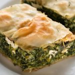 Spinach pie is a Greek delicacy also known as “Spanakopita.” If you haven’t tried this delectable treat yet, now is the time! Made with layer upon layer of crunchy phyllo dough, filled with spinach and feta cheese, and baked to golden perfection, spinach pie is a comforting, filling, and scrumptious food.