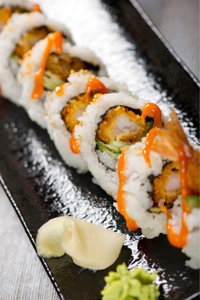 Get ready for an explosion of flavors with this easy-to-make sushi roll! A Dynamite Roll features crispy tempura shrimp, avocado, cucumber, mango and a delicious sauce that simply tantalizes your taste buds. A beautiful combination of sweet and savory flavors, we highly recommend serving this roll as a dinner party appetizer. However, we also understand if you decide to keep this delicious secret to yourself.