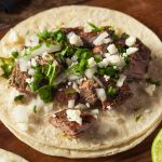 Marinated Skirt Steak Tacos are tender, juicy and flavorful. Also known as Carne Asada Tacos, this mouthwatering Mexican dish will have you going back for seconds. By combining the marinated skirt steak with delicious toppings, these tacos are always a winner.