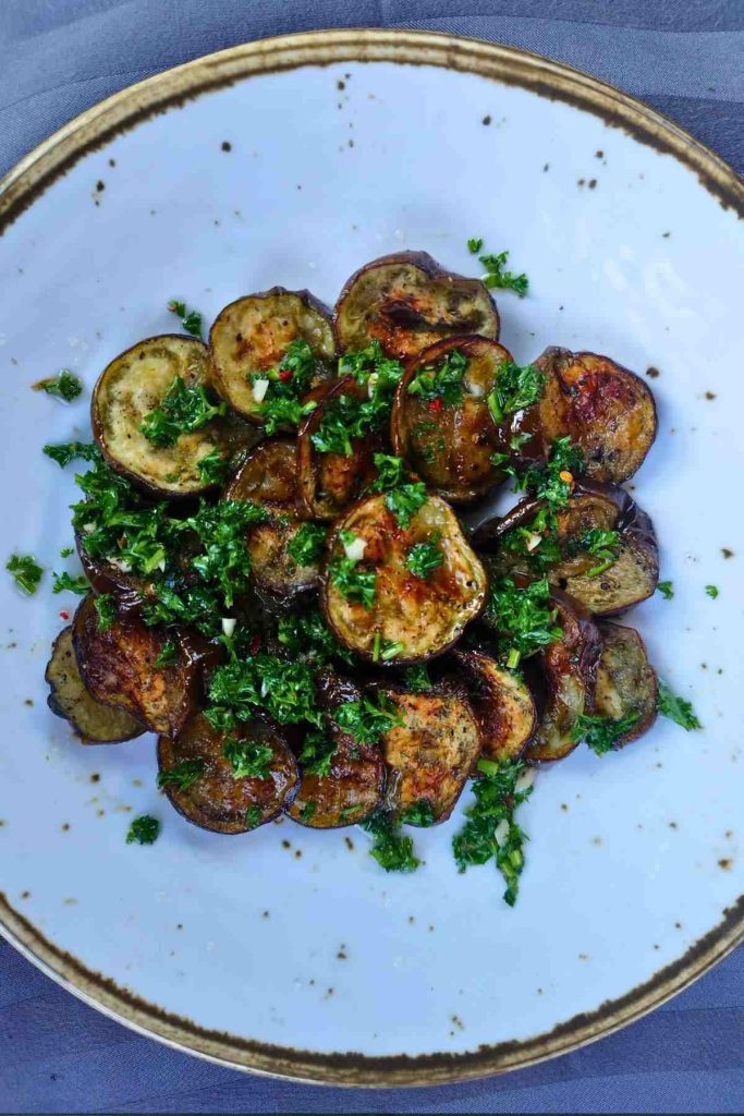 You will not believe how DELICIOUS these Roasted Eggplant Slices are! Each slice is perfectly caramelized on the outside, while the inside is perfectly tender and juicy. Once drizzled with my homemade chimichurri sauce, the flavor will blow your mind away!