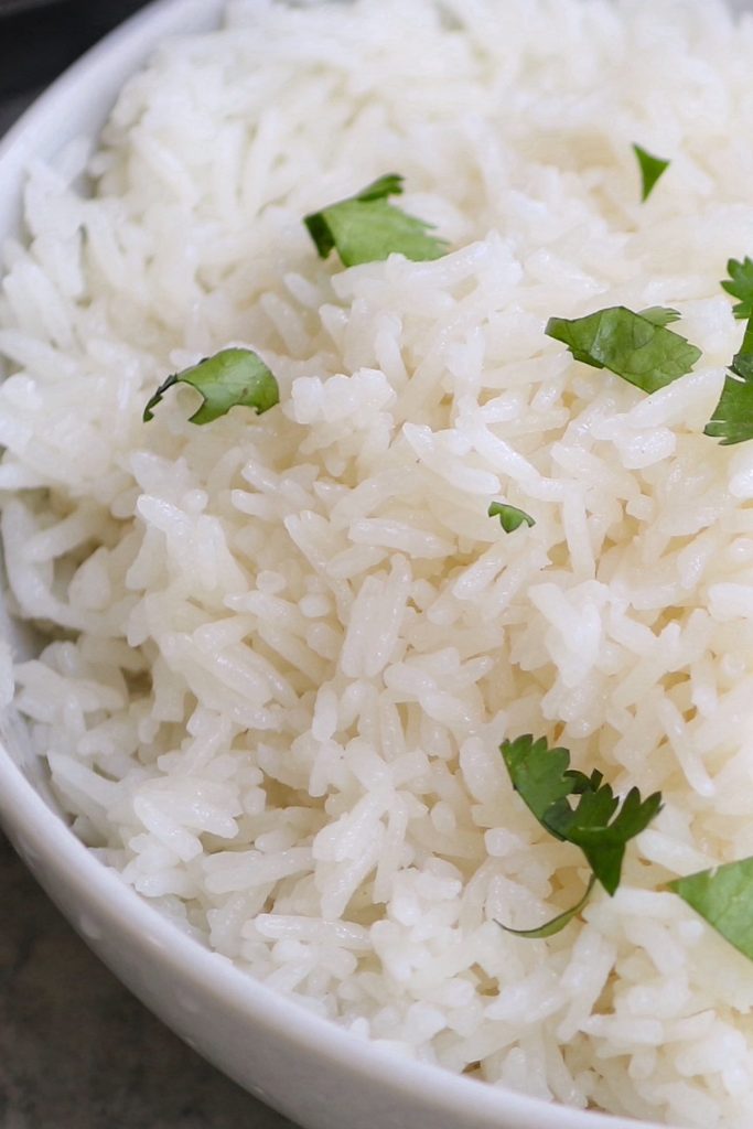 The easiest and foolproof way to make restaurant-quality Coconut Rice is to cook it in a rice cooker. It comes out perfectly FLUFFY with tropical flavors of coconut ever time! It takes less than 2 minutes to put everything into the rice cooker. Jasmine rice and coconut milk cook together in the rice cooker for a super delicious side dish!