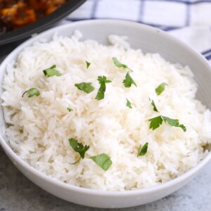 Making coconut rice in a rice cooker is a convenient and the easiest way to prepare this flavorful dish. Simply rinse, cook, and fluff the rice, that’s it! The rice comes out perfectly fluffy, creamy, and flavorful every time! So much easier than using the stove. Serve it with curries, stir-fries, stewed meats, and veggies.