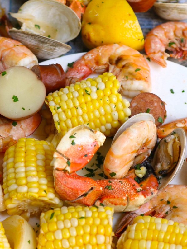 No false promise: this is a seriously impressive Seafood Boil that is made entirely in one LARGE pot in 30 minutes! This Southern crowd-pleaser includes crabs, clams, shrimp, sausages, potatoes, and sweet corn, all boiled together in a flavorful Cajun broth! Serve it with a popular Seafood Boil Sauce for the most satisfying meal!