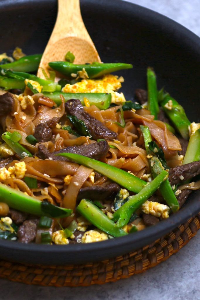 This homemade Pad See Ew recipe is loaded with tender wide rice noodles, Chinese broccoli, protein of your choice (beef, chicken, shrimp, or tofu), scrambled eggs, and coated with a savory and sweet sauce. Ready in less than 30 minutes!