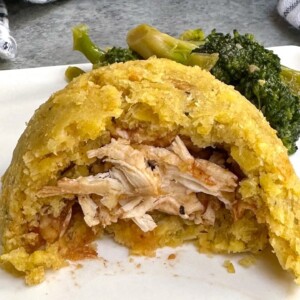 Seasoned with garlic and oil, then mixed with crispy pork cracklings, this Puerto Rican chicken stuffed mofongo is made with fried green plantains. It’s smooth, soft, and creamy. Serve it fresh and hot as a delicious side dish or main with your favorite sauce.