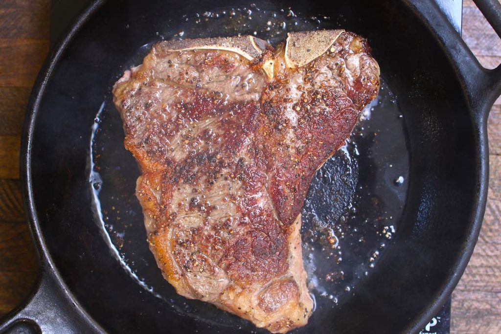 Searing T bone steak in a cast-iron skillet