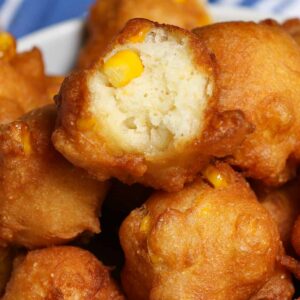 Appetizer recipes &ndash; golden fried corn nuggets with one split open showing the corn kernel filling inside