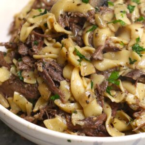 Pasta recipes &ndash; beef tips and egg noodles with mushrooms and parsley in a bowl